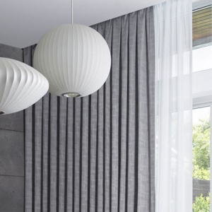Grey drapes with sheer curtain and paper lantern lights